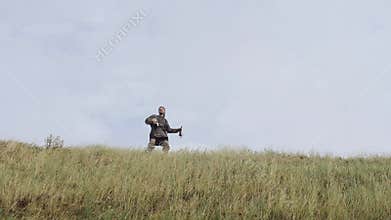 Viking blowing into the horn, calling reinforcements