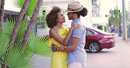 Couple standing and embracing on the street