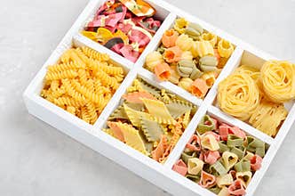 Variety of types and shapes of raw Italian pasta.