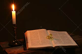 Bible prayer book candle