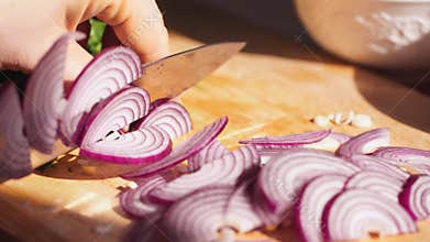 Rapidly Chopping Onion, Close-Up. Slow mothion. red onions close up. Female hands cut onions in kitchen. Macro shooting