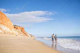 People walking on Falesia Beach with beautiful cliffs, Albufeira, Algarve, Portugal