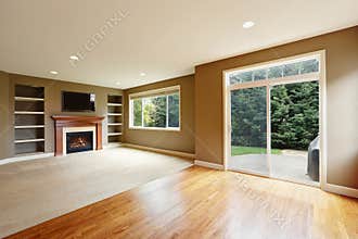 Brown living room interior with fireplace and bookshelves.