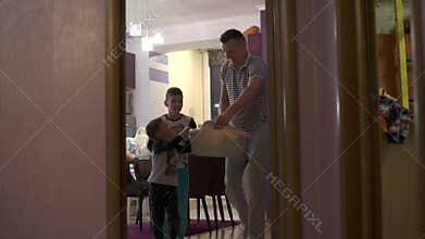 Children help the dad to carry the washed clothes. They are preparing for the arrival of my mother.