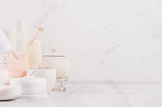 Luxury organic body and skin care spa light cosmetics collection and natural bath accessories on white wood background.