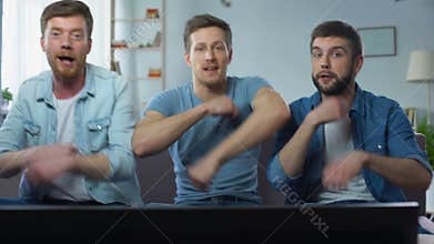 Cheerful funny guys dancing on sofa, rejoicing good finals of sport competition