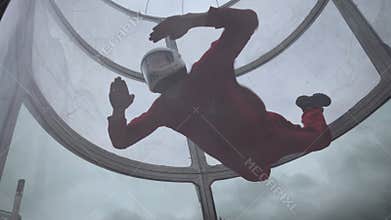 Girl flying trains with a parachute jump. Extreme parachuting. Simulator flying with a parachute