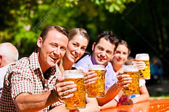 Two happy couples sitting in Beer garden
