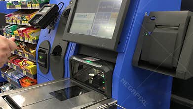 The motion of man paying credit card for foods at self-check out counter