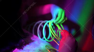 Close up the hand of little try to solve the entanglement of rainbow spring toy