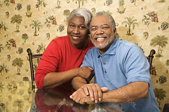 Mature couple embracing and smiling.