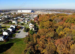 The aerial view of the neighborhood and the new Amazon Warehouse surrounded by stunning colors of fall foliage near Wilmington,DE