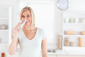 Charming woman drinking water