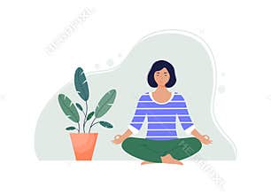 Young woman meditates in lotus position with closed eyes