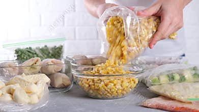 Frozen food. Frozen corn is poured from plastic bag into the glass bowl