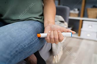 Woman Injecting Epinephrine Using Auto-injector Syringe