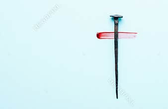 Christian cross made with rusty nails, drops of blood on blue background. Copy space. Good Friday, Easter day. Christian