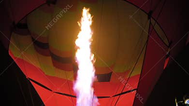 Fire from gas jet burner in hot air balloon flame rising at night