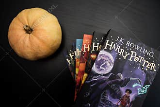 MADRID, SPAIN - MARCH 30, 2021: Complete collection of books of fictional saga of Harry Potter by JK Rowling on a black table with