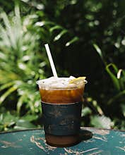 Iced cold brew coffee with lemon on a table