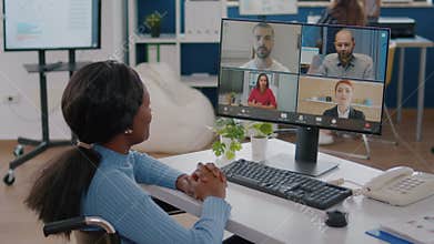 Handicapped african manager woman discussing with remote colleagues