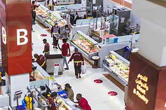 Dubai, UAE - 07.07.2021 - Customers and vendors at Waterfront market, meat and poultry section. Trading