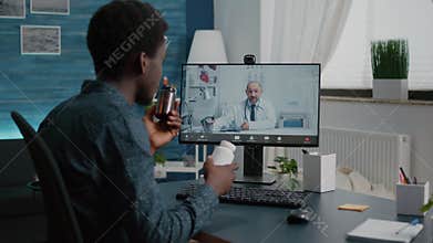 Online internet health checkup of black man talking with family doctor
