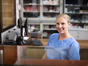 Woman working as nurse at reception desk in clinic