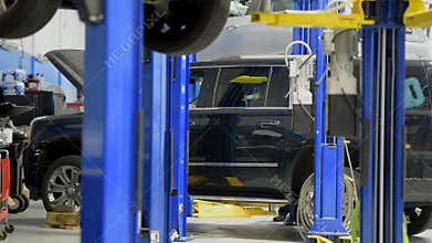 Auto Service and Broken Car on an Automotive Lift