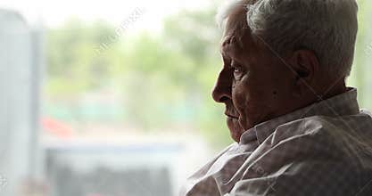 Upset older man sit on sofa lost in sad thoughts