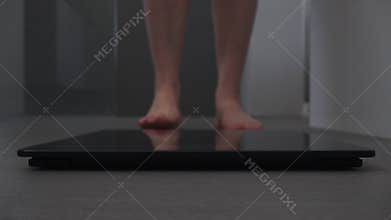 Adult woman measuring herself on a weight scale
