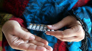 Women hand holding birth control pills close up