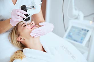 Patient smiling during the skin rejuvenation procedure