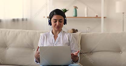 Happy young biracial lady communicating distantly indoors.