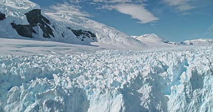 Slow motion of snow covered Antarctic ocean bay aerial view. Environment preserve and climate change