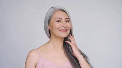 Senior happy middle aged mature asian woman portrait. Hair care advertising.