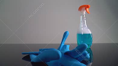 Rubber gloves and cleaning solution Placed on the table