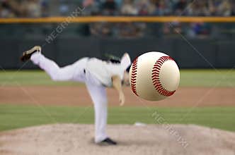Baseball pitcher throwing fast ball to batter in a stadium