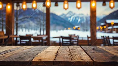 Empty wooden tabletop inside chalet restaurant overlooking snowy mountain view