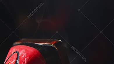 Close-up of smoke from wax compound used to treat the sliding surfaces of snowboards and skis. Low key. Shallow depth of