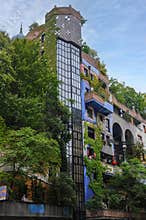 Hundertwasser house in Vienna overgrown with plants and trees