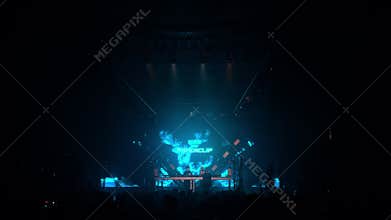 Russia, St.Petersburg, 23 December 2023: A lot of people at a fancy party in a huge club, a colorful light show and a