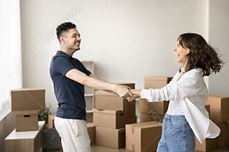 Happy excited young husband and wife celebrating first house buying