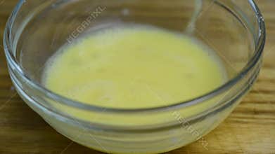 Dip the prepared, peeled, raw shrimp into the beaten egg.