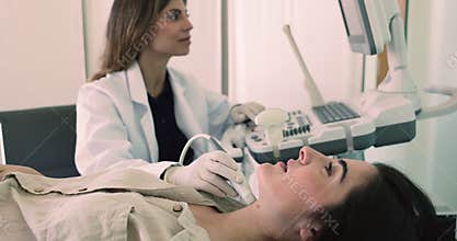 Endocrinologist check patient thyroid gland using modern ultrasonography equipment, closeup