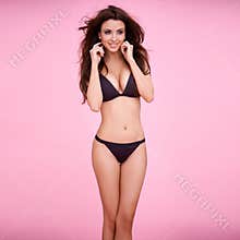 Smiling brunette in black bikini