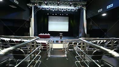 Stairs among seats in empty illuminated auditorium