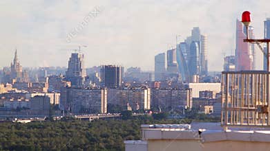 Red beacon on tall building and modern skyscrapers