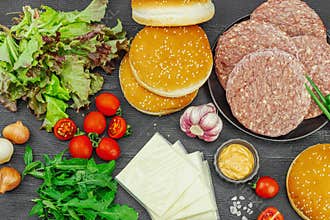 Burger patties. Beef cutlets, buns, vegetables and sauce. Homemade American classic