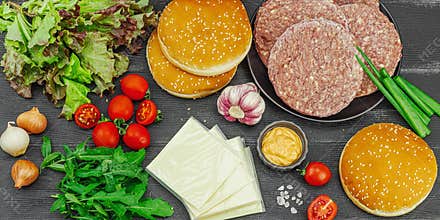 Burger patties. Beef cutlets, buns, vegetables and sauce. Homemade American classic